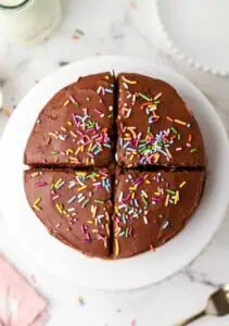 mini chocolate cake on a cake stand cut into four servings