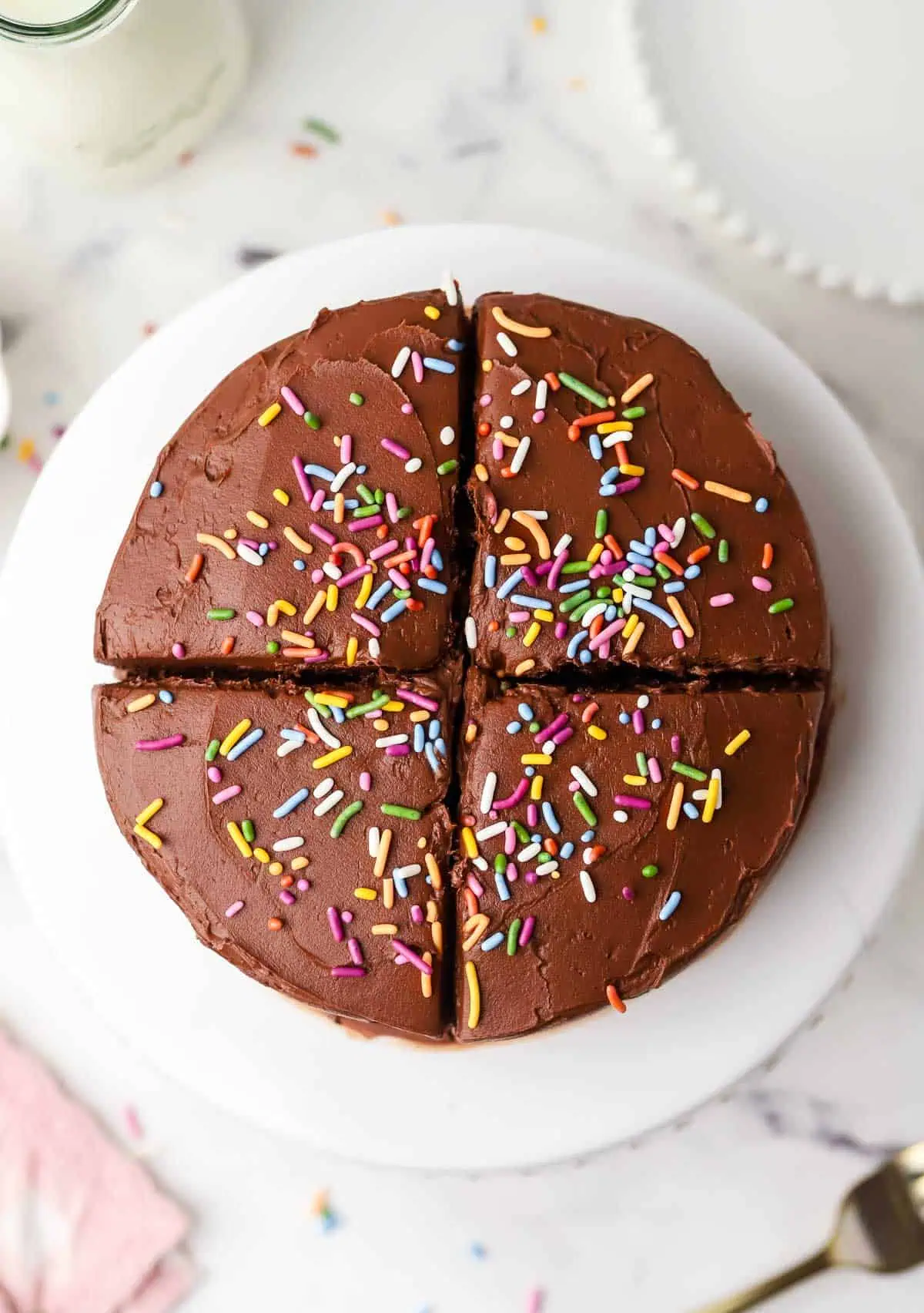 mini chocolate cake on a cake stand cut into four servings
