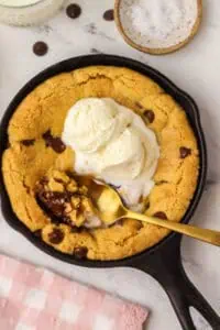 mini cookie skillet topped with ice cream and a spoon in it