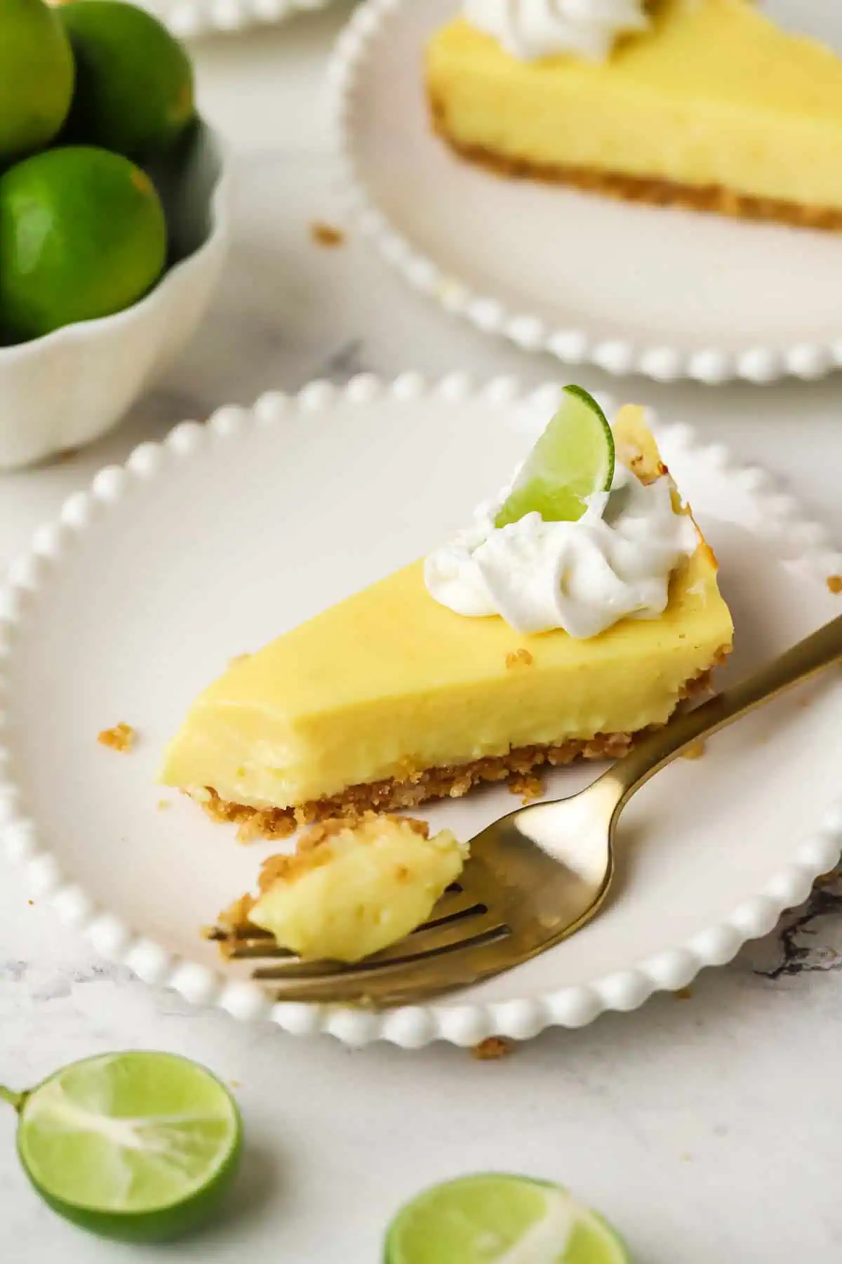 slice of small batch key lime pie on a plate with a fork