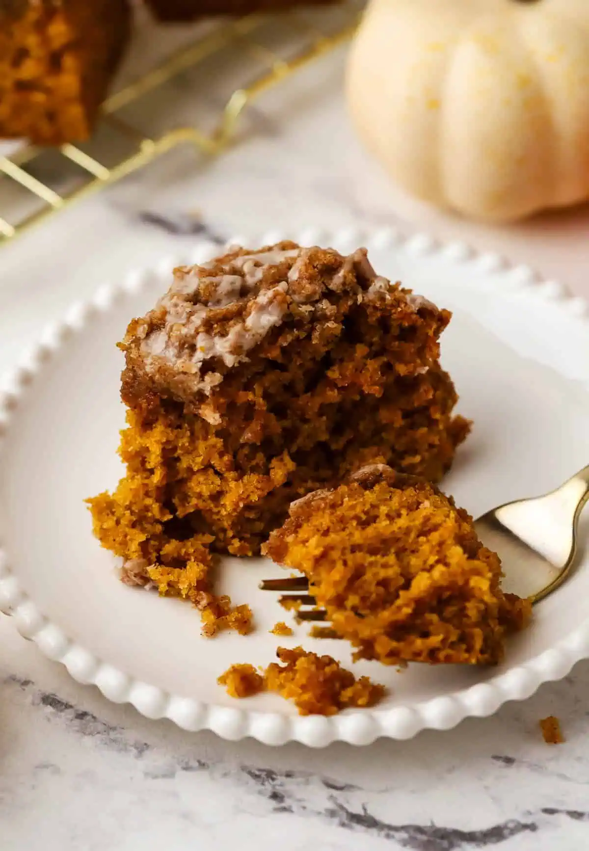 slice of pumpkin coffee cake with a fork on a plate