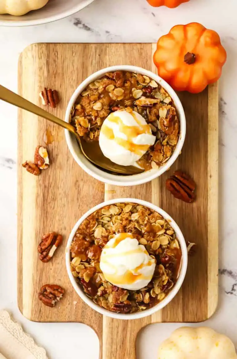 two pumpkin crisp ramekins topped with ice cream