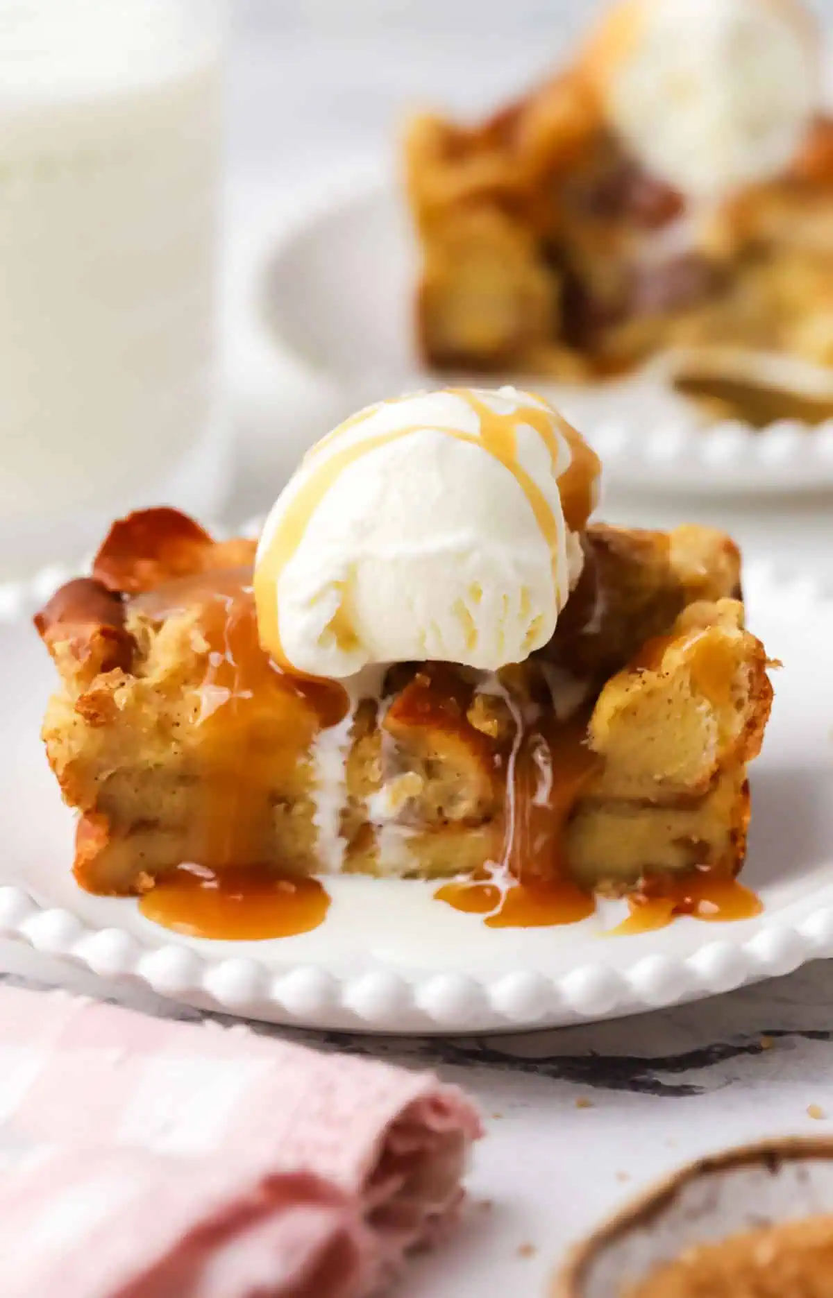 slice of small batch bread pudding topped with ice cream and caramel