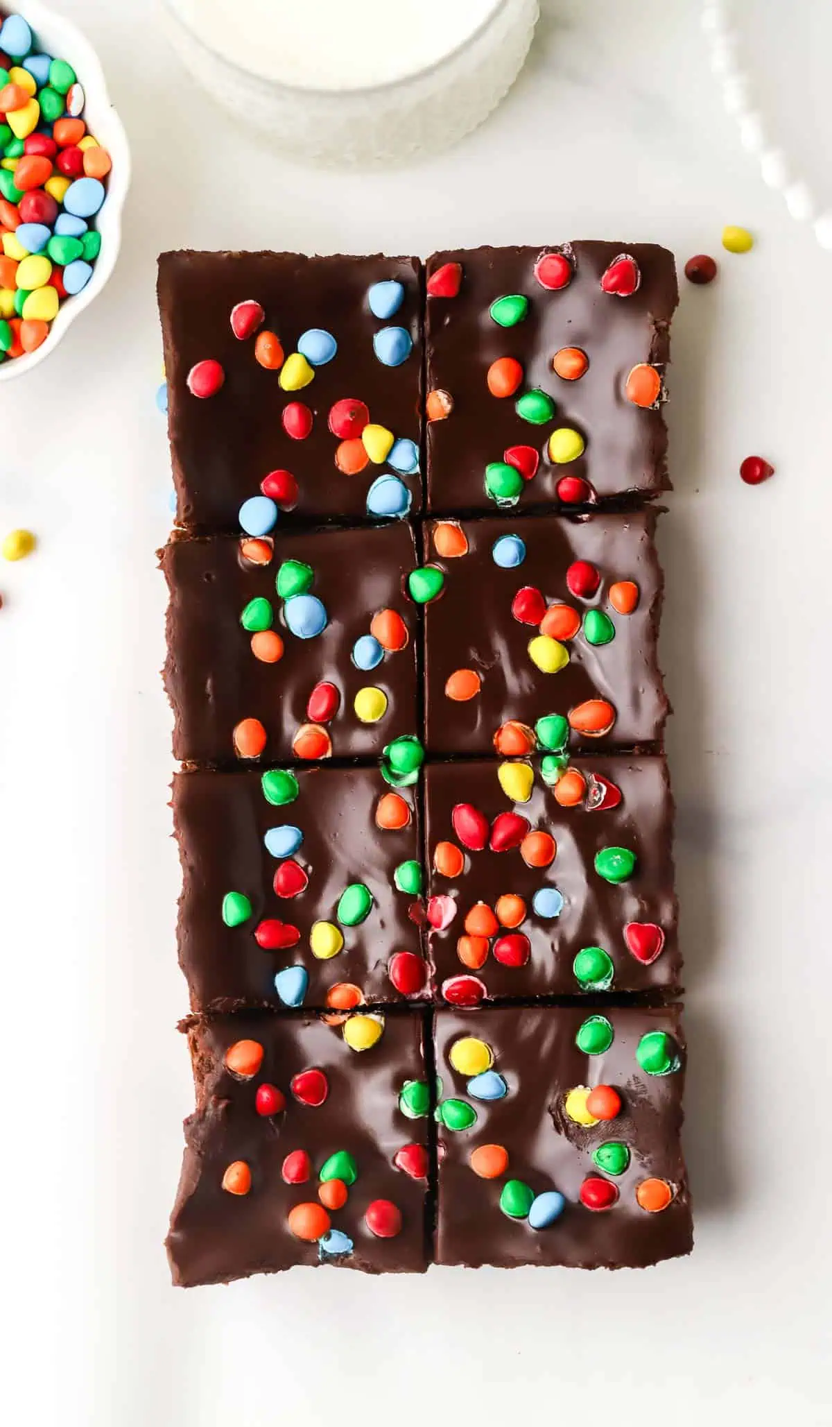 small batch cosmic brownies cut on a piece of parchment paper