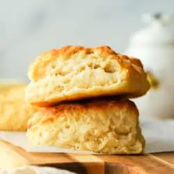 two buttermilk biscuits stacked on top of each other