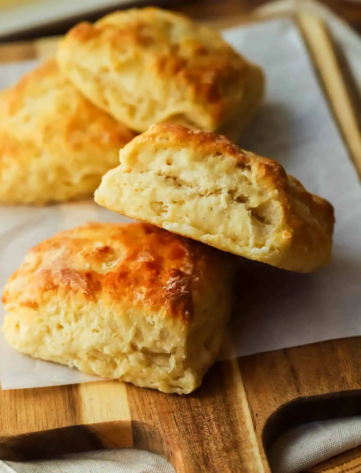 four biscuits on a cutting board