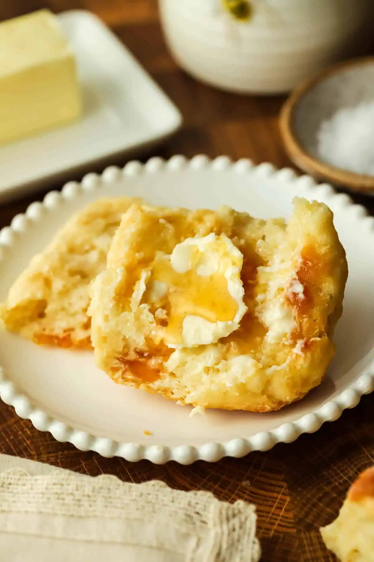 a biscuit topped with butter and honey