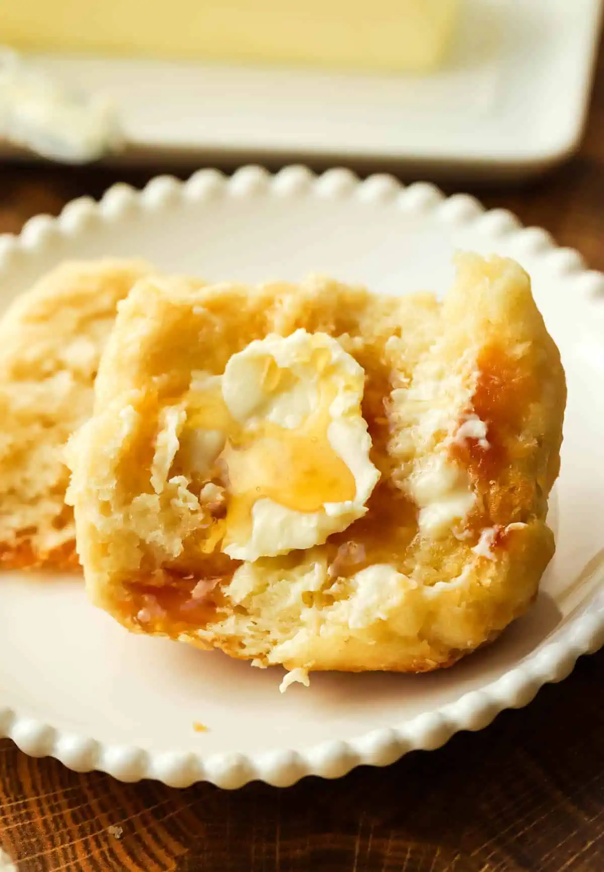 a biscuit topped with butter and honey