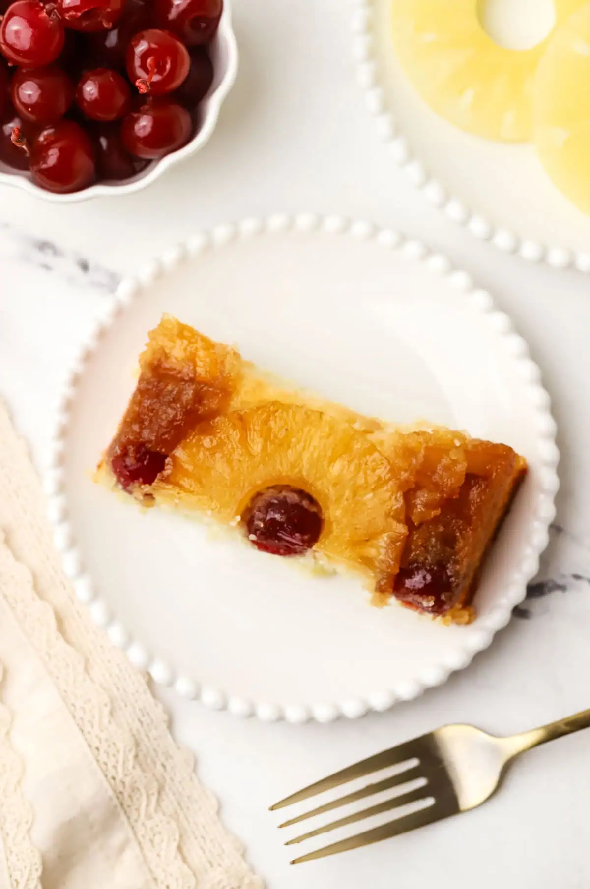 top down view of a slice of small batch pineapple upside down cake on a plate