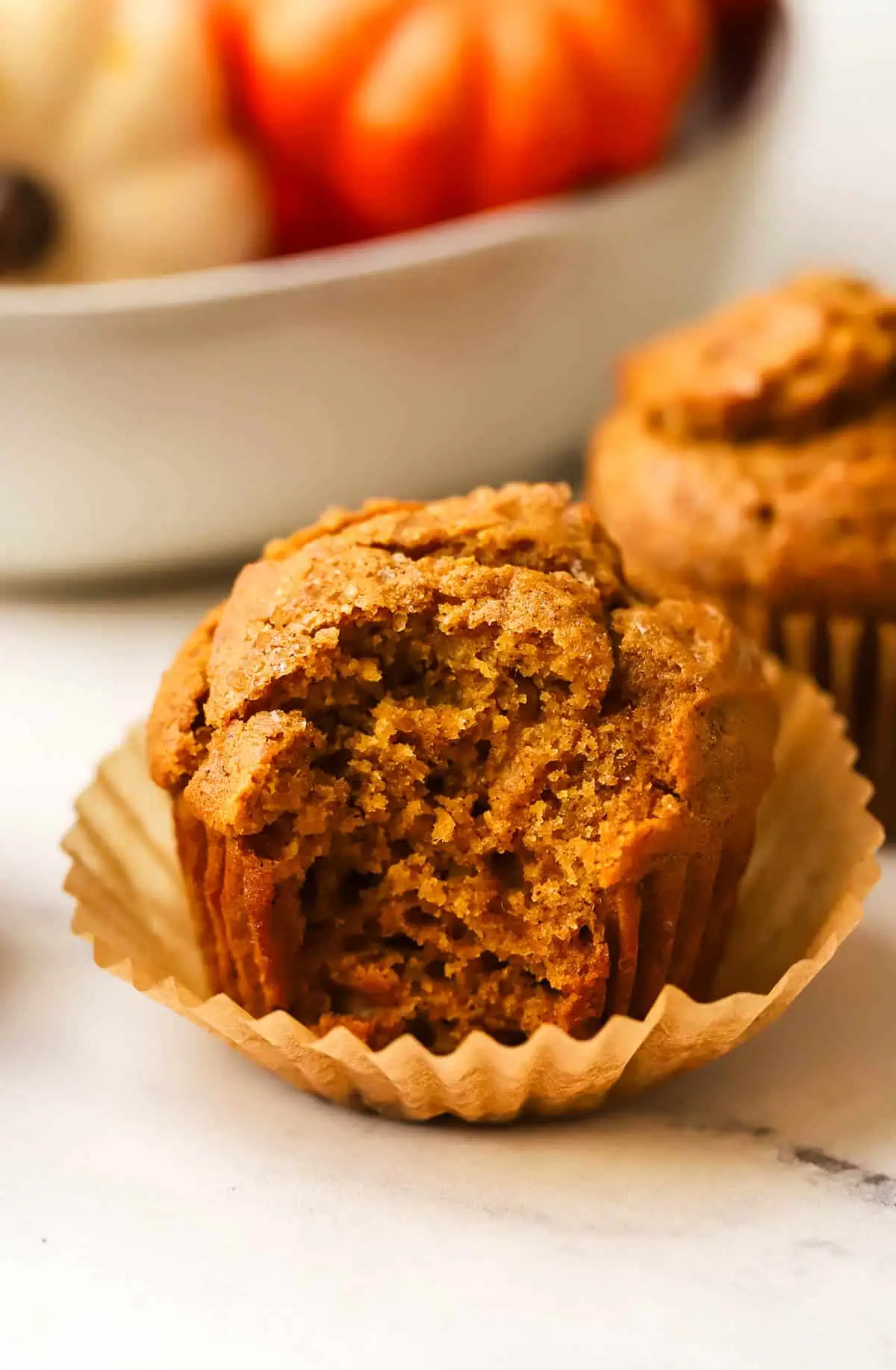 a small batch pumpkin muffin with a bite taken out of it