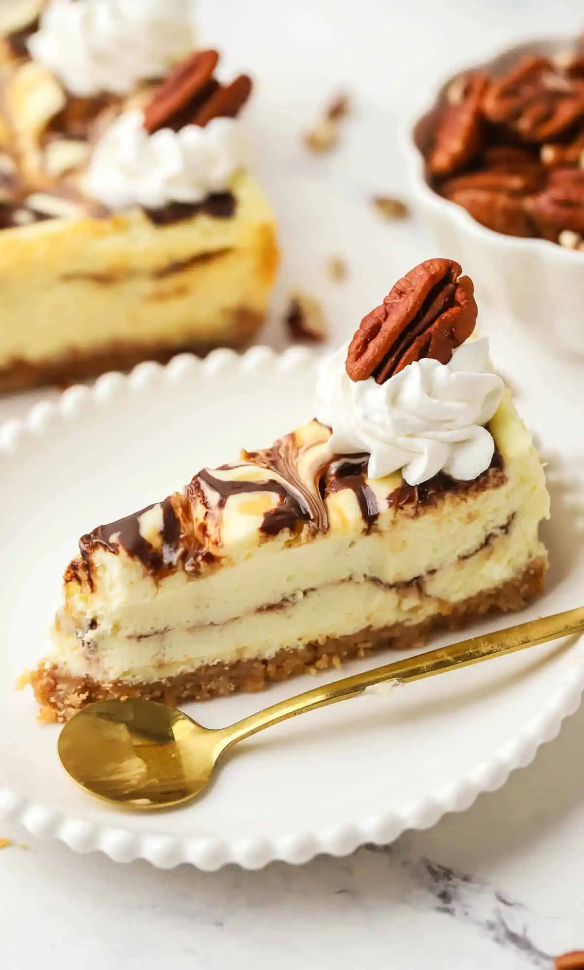 slice of turtle cheesecake on a plate with a spoon