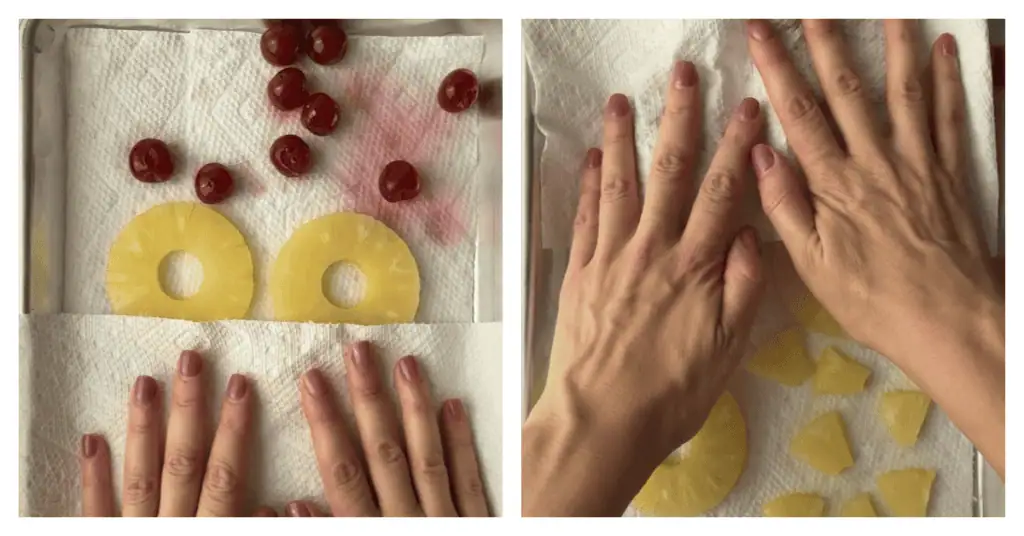 two hands blotting pineapple and cherries with paper towels