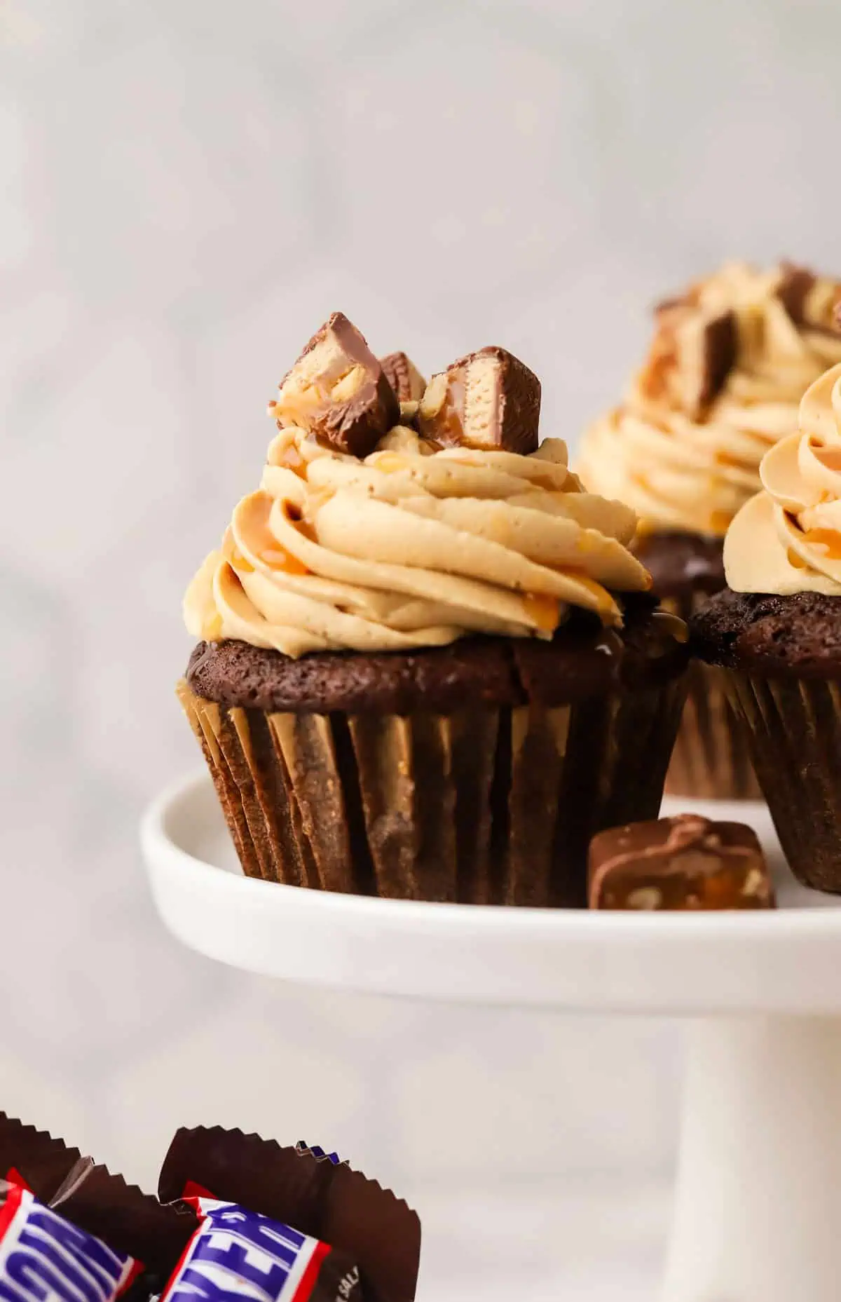 snickers cupcakes on a cake stand